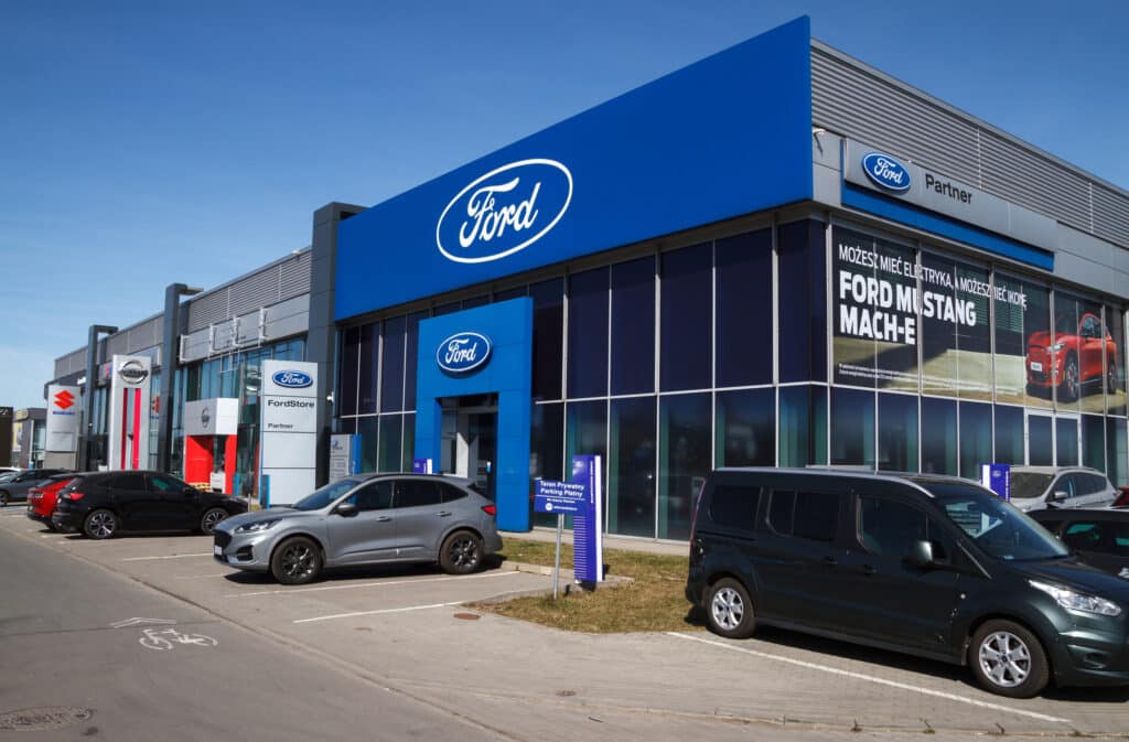 ford cars dealership building entrance, with logo sign.