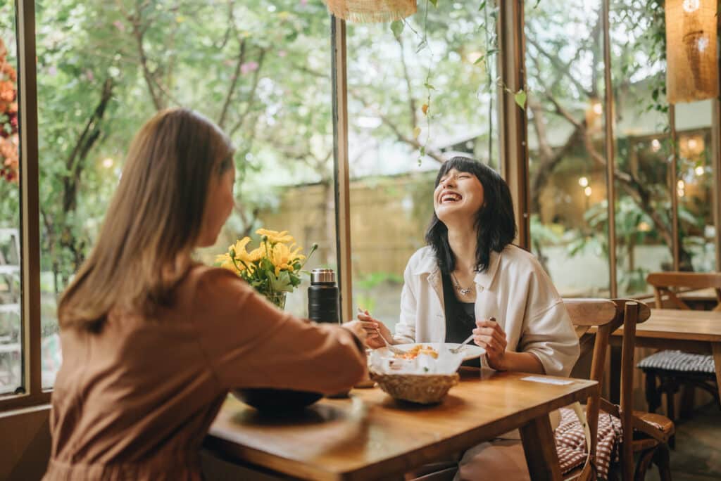 a sweet lesbian couple enjoying a delicious meal. outside on the holiday of love together with music services