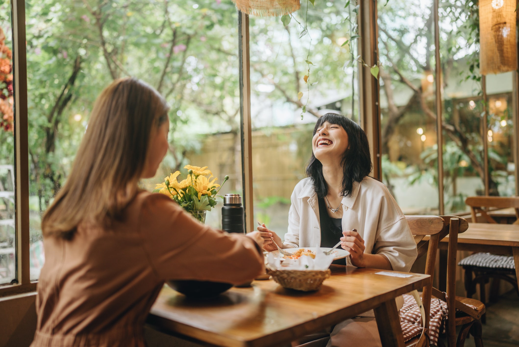a sweet lesbian couple enjoying a delicious meal. outside on the holiday of love together with music services